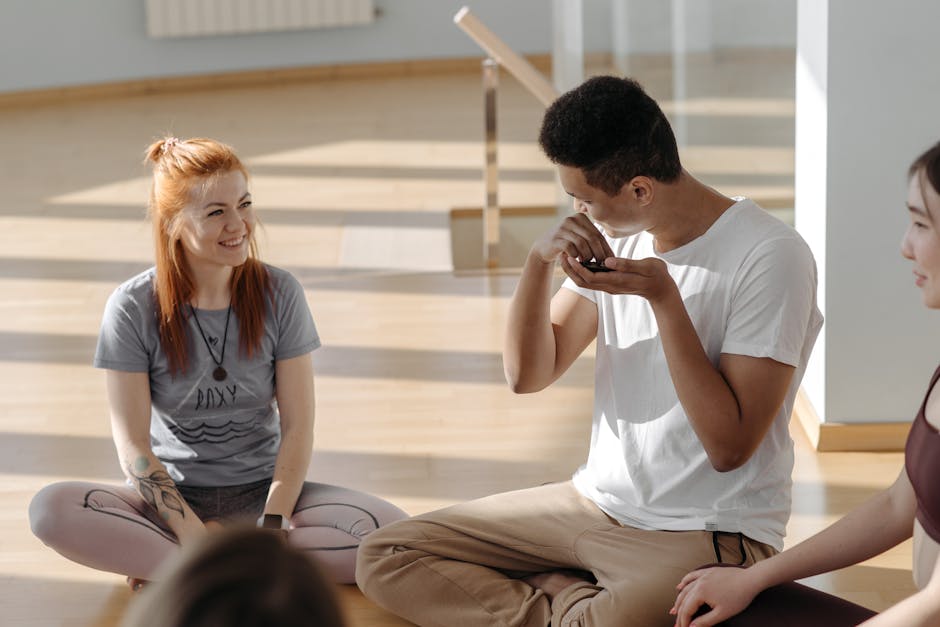 Diverse group of people meditating in a sunlit yoga studio